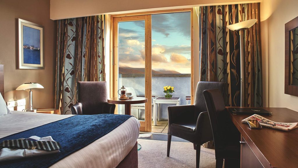Bedroom with a view of the sea. Choose the most popular hotels in Ireland when you book a Great National Hotels and Resorts property.